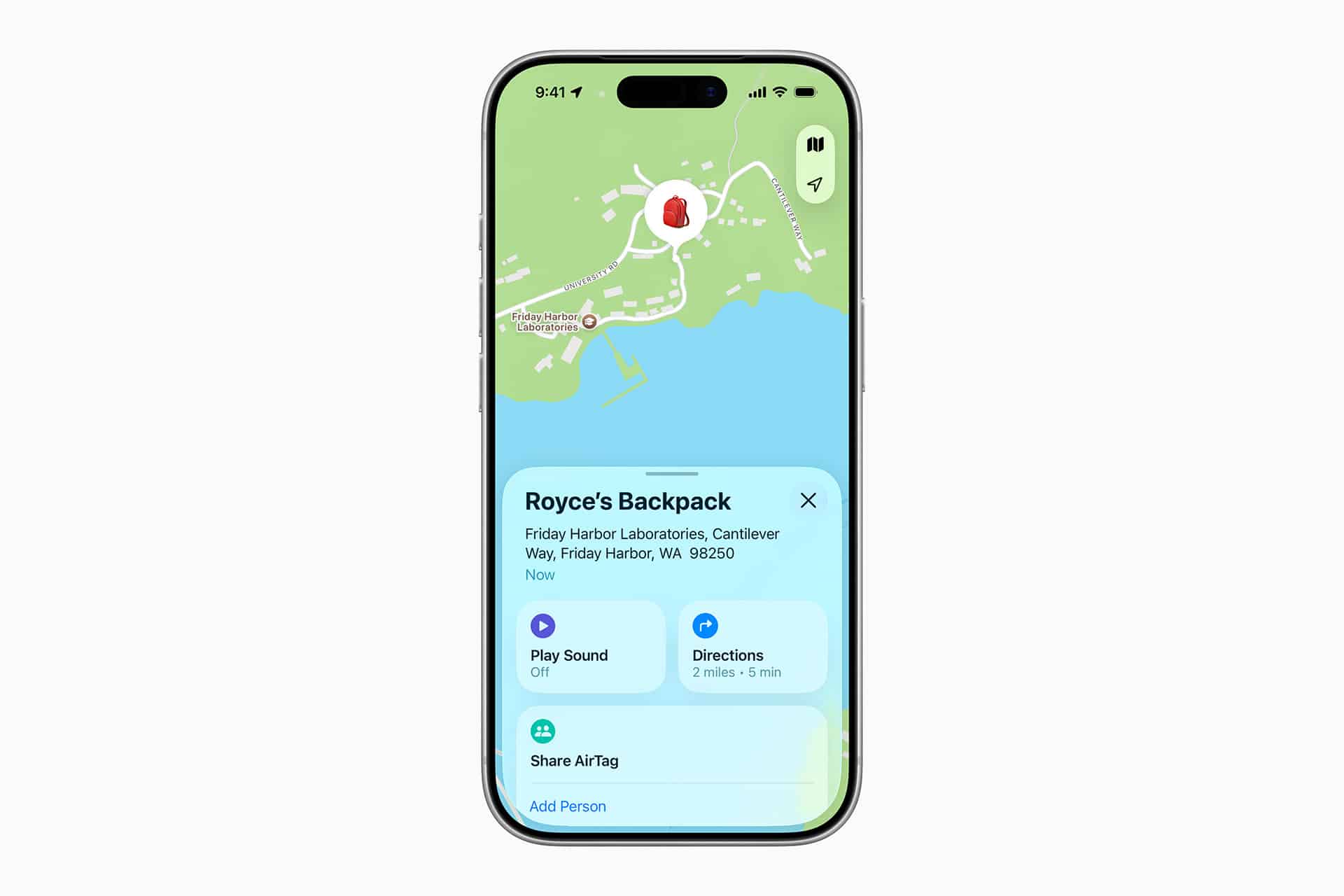 An iPhone screen displays the Find My app, showing the location of Royce's New AirTag-equipped backpack on a map near water in Friday Harbor, WA. Options to play a sound, get directions, and share AirTag are visible.