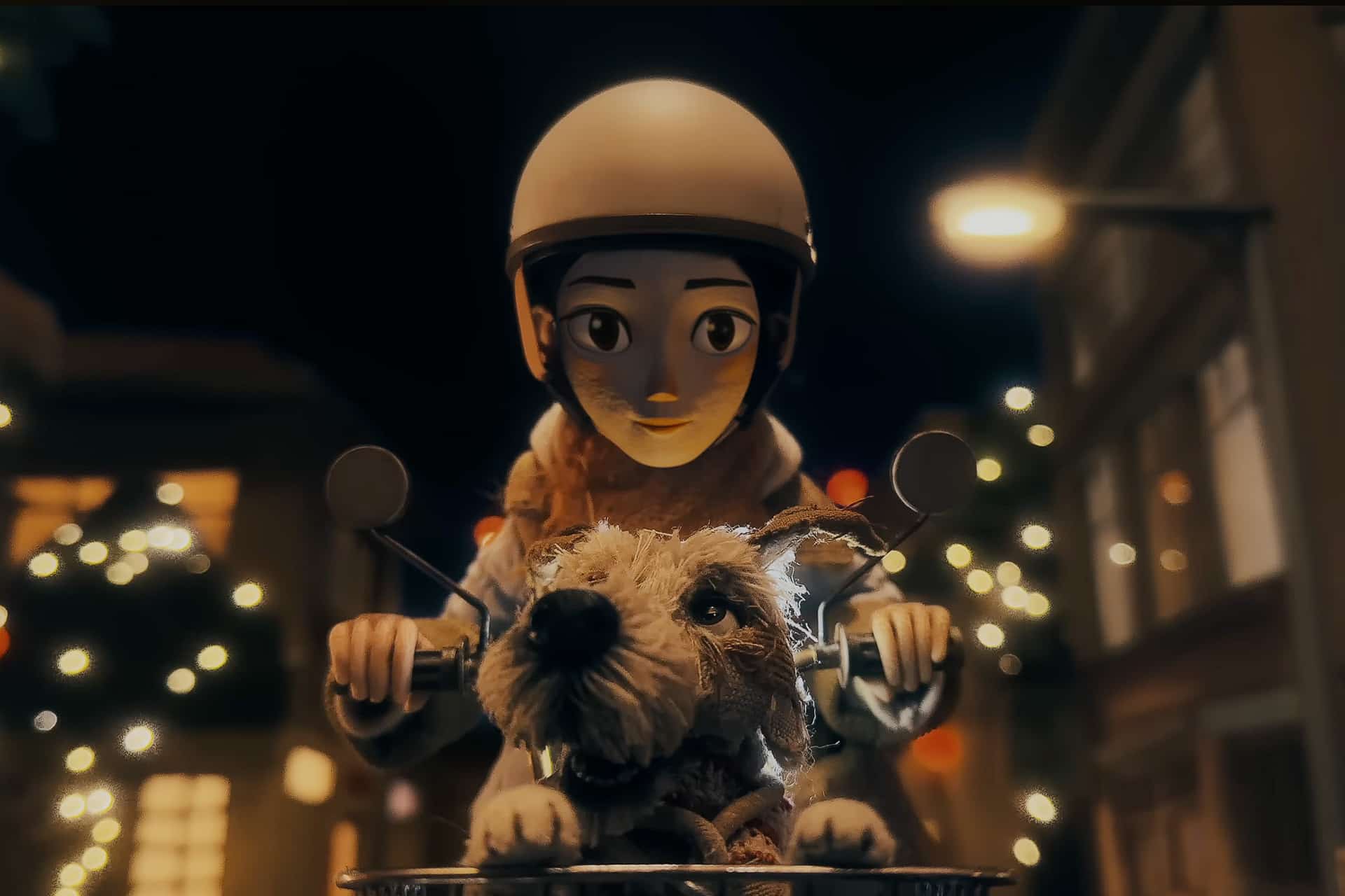 A stylized animated character rides a scooter at night, wearing a helmet and scarf, with a small, scruffy dog in the front basket. Softly lit buildings and glowing streetlights fill the background—capturing a magical moment shot on iPhone.