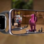 A smartwatch and a smartphone display a fitness workout. The watch shows workout stats, while the phone features Apple Fitness+ with a woman in pink exercising indoors and additional data on screen. The Apple logo is in the corner.