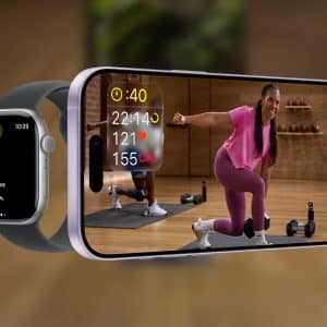 A smartwatch and a smartphone display a fitness workout. The watch shows workout stats, while the phone features Apple Fitness+ with a woman in pink exercising indoors and additional data on screen. The Apple logo is in the corner.