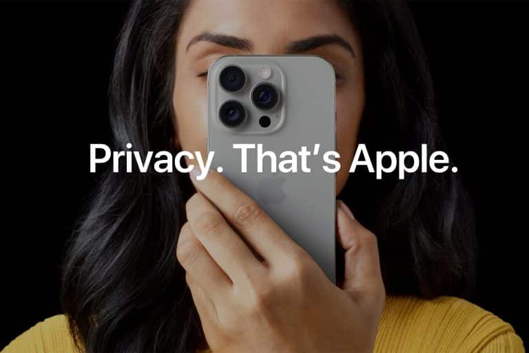Apple Privacy - A person holds an iPhone in front of their face, partially covering it. Overlaid text reads, "Privacy Audit. That’s Apple." The person has long dark hair and is wearing a yellow top.