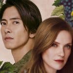 A man with straight black hair and a woman with long, light brown hair stand close together in front of a floral background with green grapevines, leaves, grapes, and a yellow butterfly—reminiscent of the elegant visuals in Apple TV Drops of God.