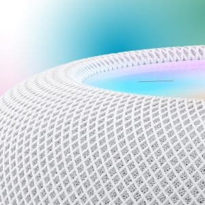HomePod - Close-up of a white mesh-textured HomePod smart speaker with a glowing, multicolored top surface; a blurred gradient background and an Apple logo appear in the upper right corner.