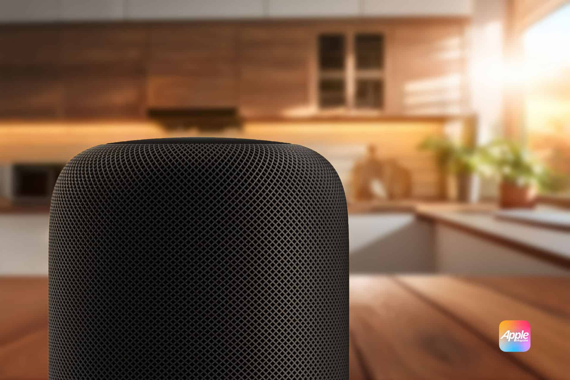 A close-up of a black Apple HomePod smart speaker on a wooden table in a modern, sunlit kitchen. The Apple logo appears in the bottom right corner.