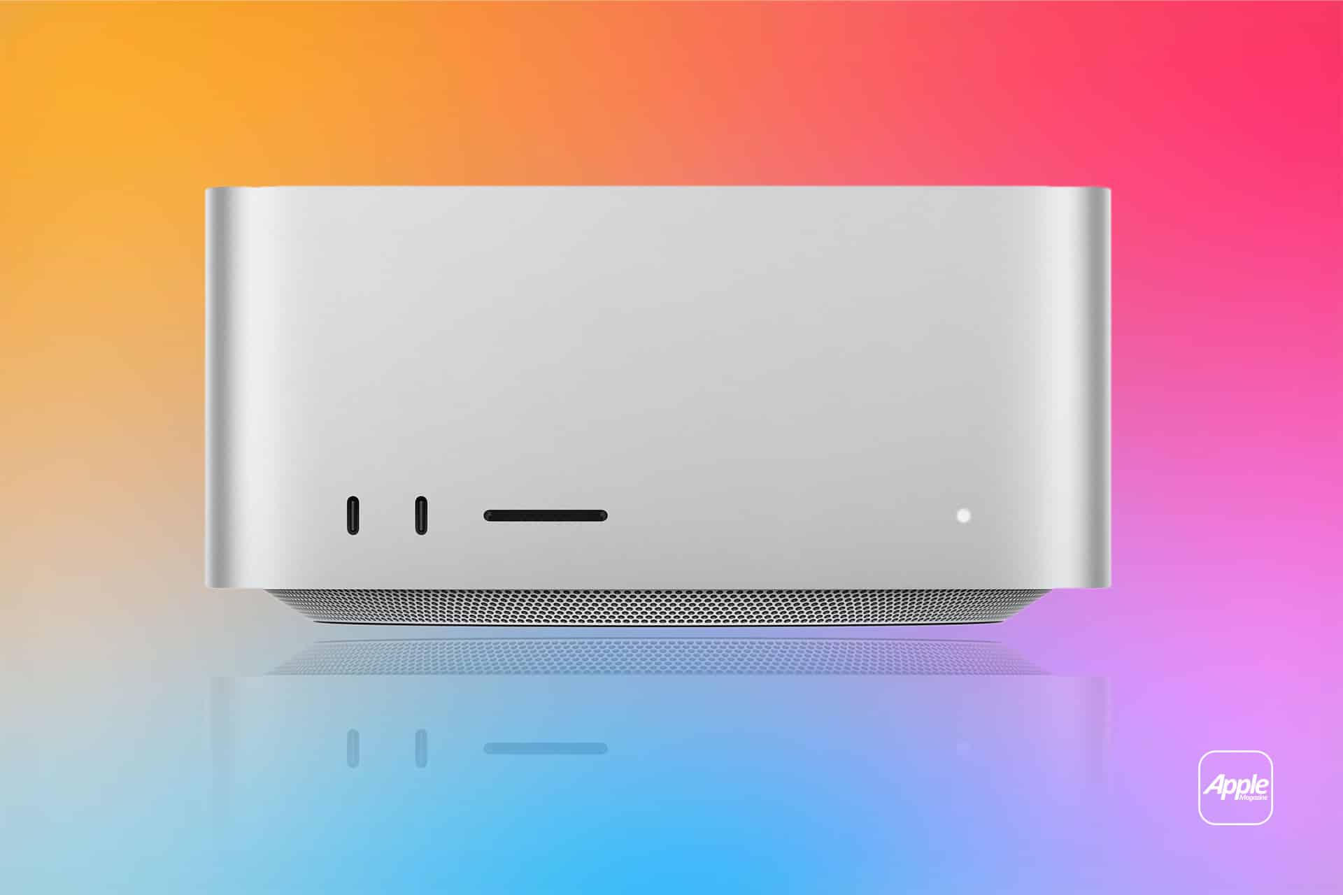 A silver Apple desktop computer with a minimalist design is shown against a vibrant gradient background of orange, pink, and blue, making it perfect for a sleek Mac Studio Setup. The Apple logo is visible in the lower right corner.