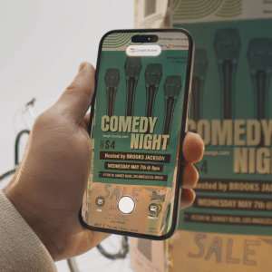 A hand holds a smartphone, capturing a photo of a comedy night poster. The phone screen displays the poster and camera interface, highlighting how visual intelligence works on iPhone to recognize details like microphones and event info.