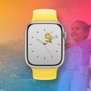 A yellow Apple Watch for Kids with a Woodstock character watch face is centered on a colorful gradient background. Two smiling children stand arm in arm on the right, partially faded behind the watch. The Apple logo sits in the bottom right corner.
