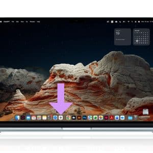 A laptop displays a scenic desert landscape as its wallpaper. A large purple arrow points to the center of the dock, highlighting Web Apps at the bottom of the screen. The Apple logo appears in the top right corner.