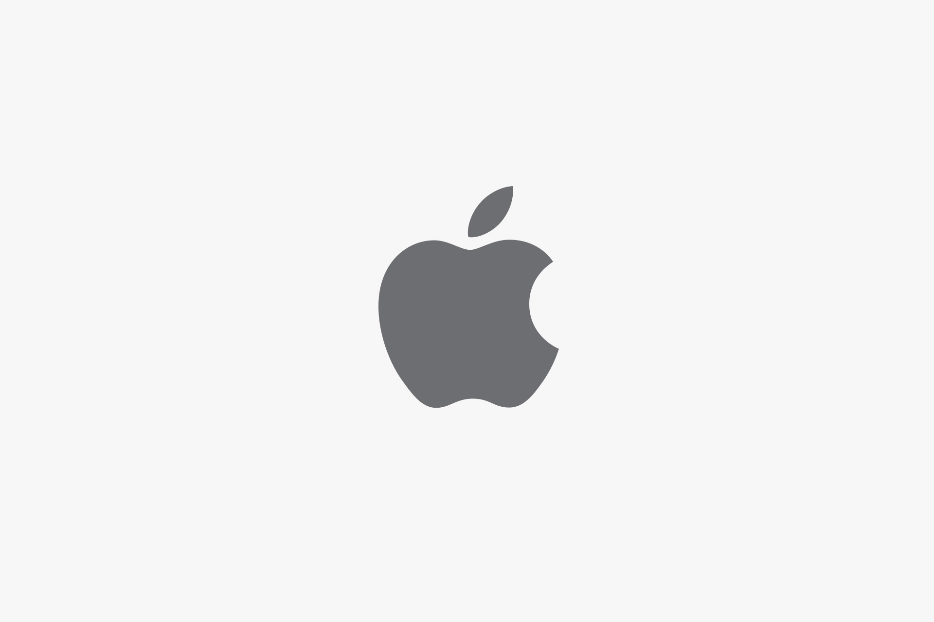 A simple gray Apple logo with a bite taken out of the right side and a detached leaf above, centered on a plain white background—perfect for showcasing the innovation behind Apple 2025 Results.