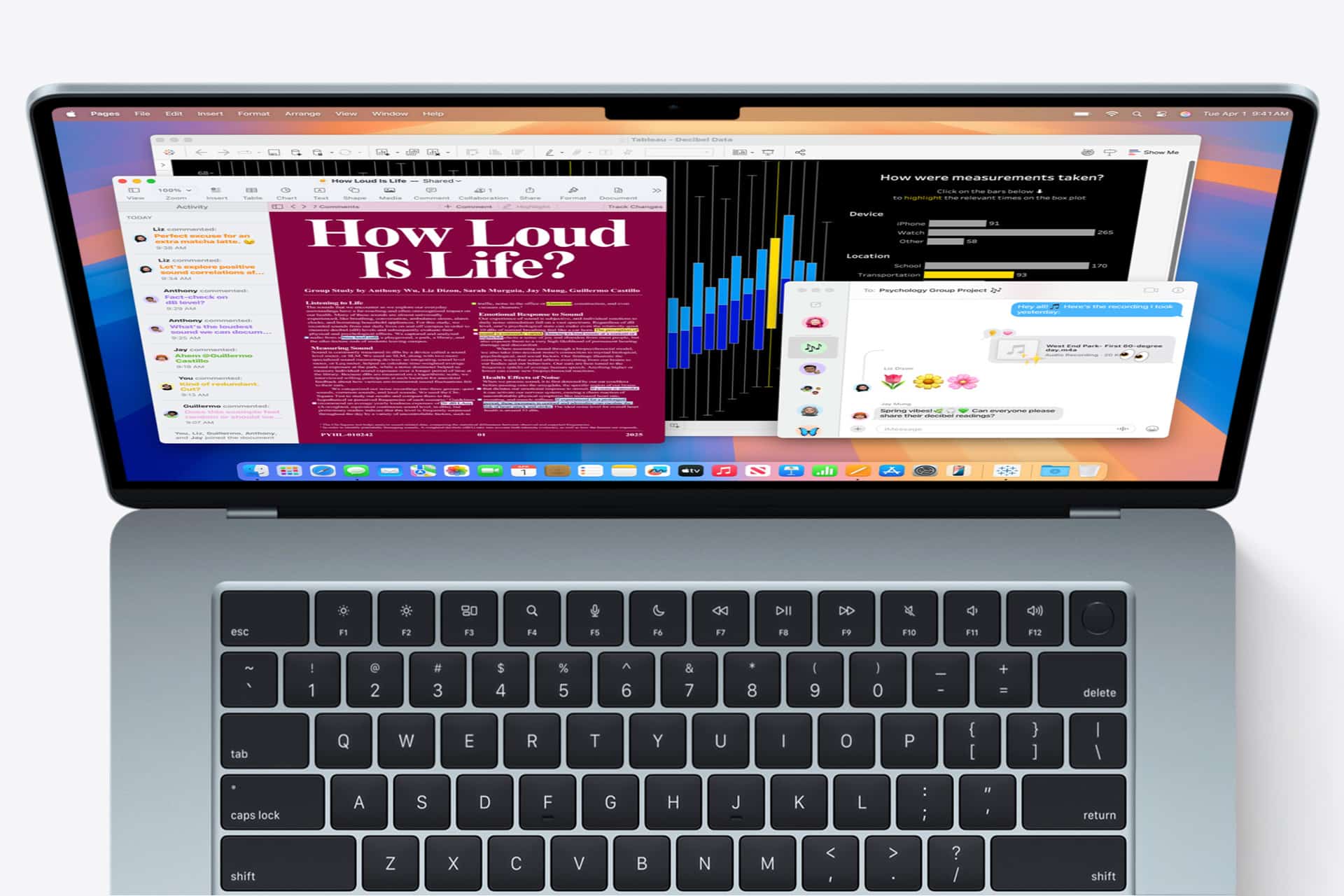 A laptop reminiscent of the First Mac displays multiple open windows—a document titled "How Loud Is Life?", a bar chart, and a chat window filled with colorful emojis. The iconic keyboard sits just below the vibrant screen.