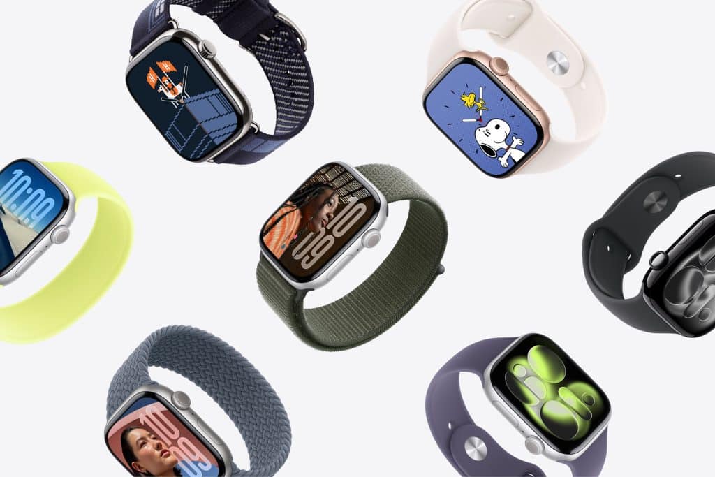 Apple Watch Band Skin Tone - Several Apple Watches with different colored bands, including options that match various skin tones, and custom watch faces like cartoon characters and digital time displays, are arranged diagonally on a light background.