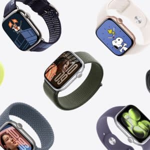 Apple Watch Band Skin Tone - Several Apple Watches with different colored bands, including options that match various skin tones, and custom watch faces like cartoon characters and digital time displays, are arranged diagonally on a light background.