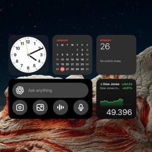 A digital dashboard with Mac Widgets displays a clock, January calendar, Monday the 26th, no events, a search bar, camera and microphone icons, Dow Jones info, and the number 49.396 over a rocky landscape at night.