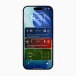 An iPhone displaying Apple Sports updates on the lock screen, including NBA scores, a soccer match between Manchester United and Manchester City, and a leaderboard for The Masters golf tournament.