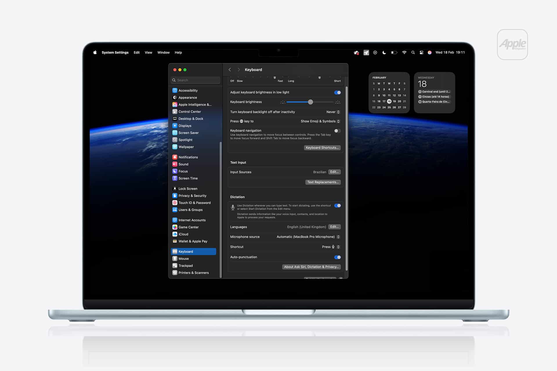 A MacBook displays System Settings with the Keyboard tab and Mac Dictation Commands visible. The screen shows keyboard options, set against a dark space-themed wallpaper, with calendar and clock widgets on the desktop.