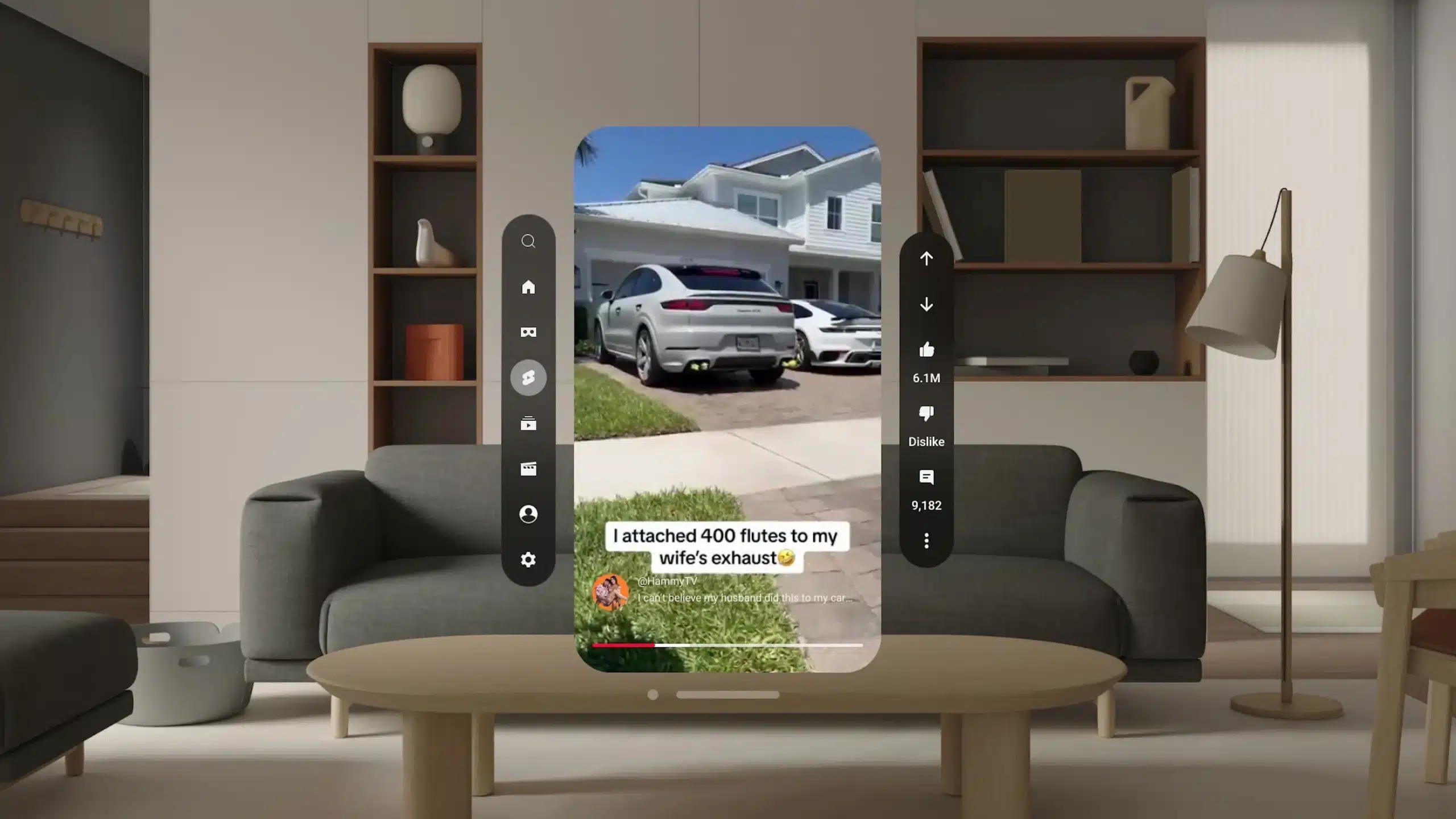 A smartphone screen displays a YouTube video of a white car in a driveway, captioned "I attached 400 flutes to my wife's exhaust," while sitting in front of a modern living room setup—perfect for streaming with Vision Pro.