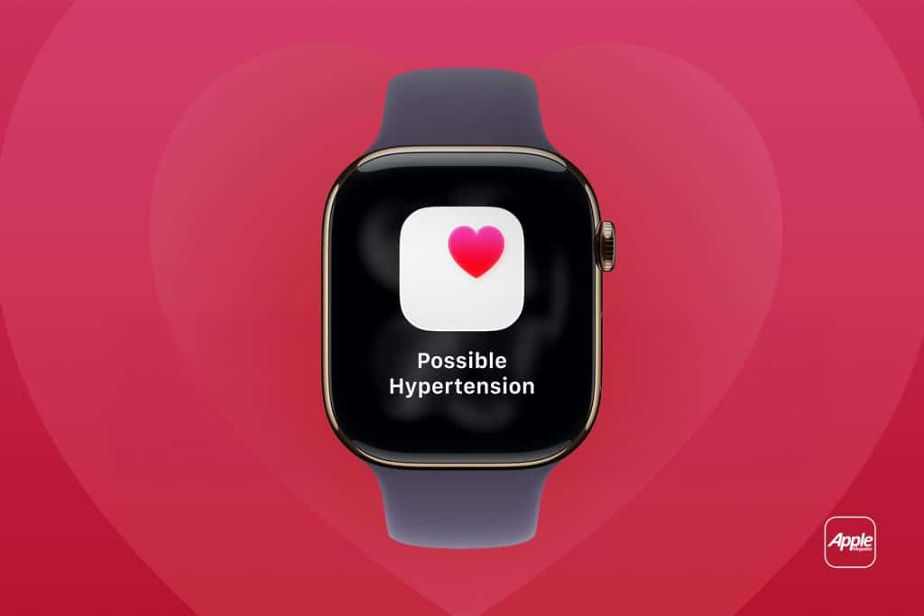 A smartwatch with a heart icon and the message "Possible Hypertension" on its screen, set against a red background with a faint heart shape and the Apple logo in the corner, highlights Preventive Heart Care features like tracking afib symptoms. - atrial fibrillation