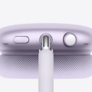 Close-up of a lavender Apple device, likely AirPods Max, showing the top with a mesh headband, buttons, a dial, and a cable plugged into the center port—perfect for tracking charge with AirPods Battery Widgets.