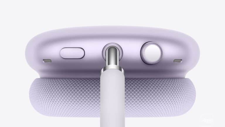 Close-up of a lavender Apple device, likely AirPods Max, showing the top with a mesh headband, buttons, a dial, and a cable plugged into the center port—perfect for tracking charge with AirPods Battery Widgets.