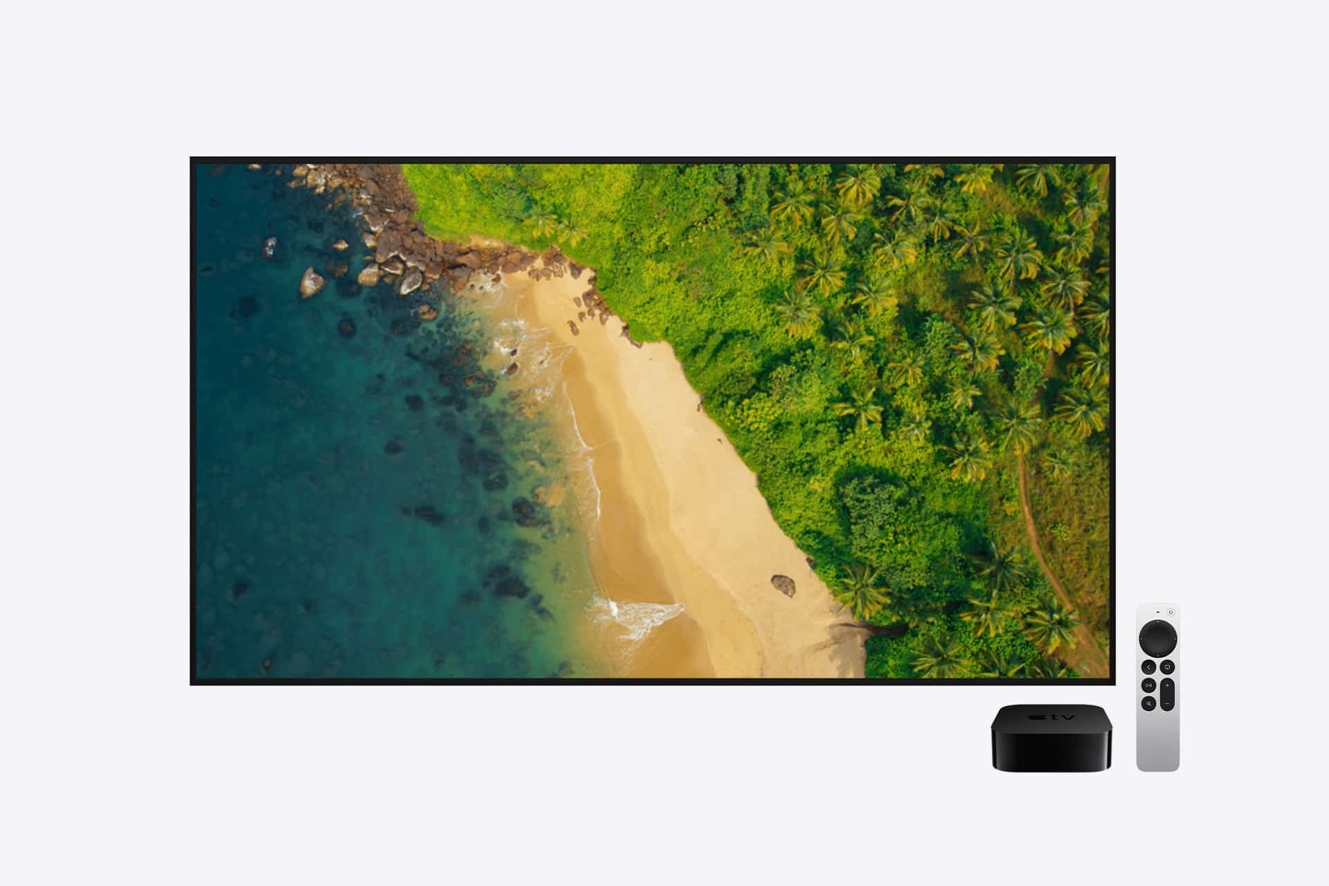A flat-screen TV displays an aerial view of a beach with blue ocean, golden sand, and green palm trees, reminiscent of Apple TV screensavers. Next to the TV are a black streaming device and a white remote control.