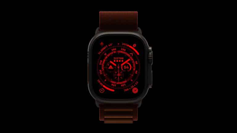 A smart watch with a dark case and brown band displays a red digital interface featuring various circular dials and numbers, all set against a black background—reminiscent of the Apple Watch Night Mode for low-light visibility.