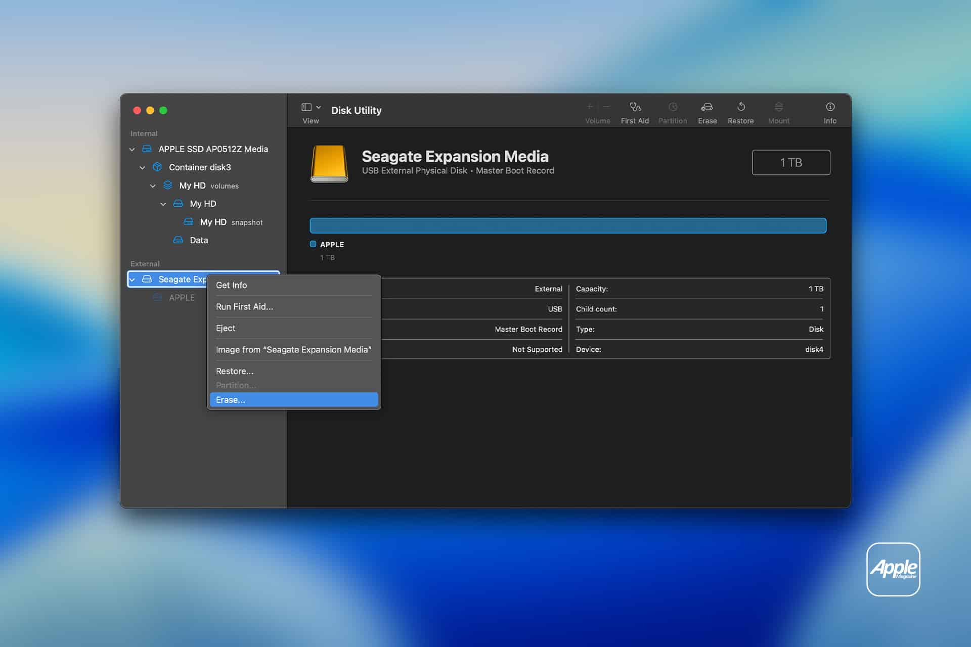 A screenshot of the macOS Disk Utility app showing a 1TB Seagate Expansion Media external drive during external SSD setup. The right-click menu on the drive highlights the "Erase…" option, with the Apple logo in the bottom right corner.