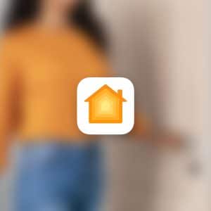 A blurred person in a yellow top and blue jeans stands by a door. In the center foreground, the Apple Home app icon highlights HomeKit Door Alerts. An Apple logo appears in the lower right corner.