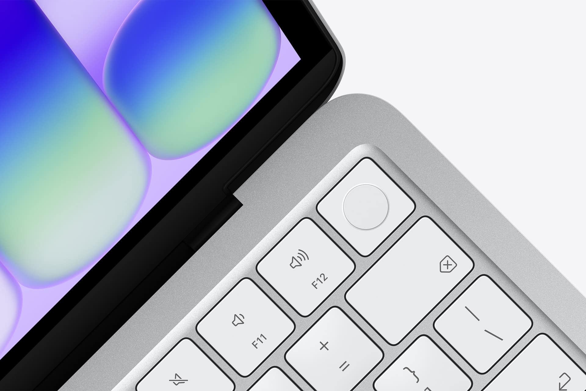 Close-up of a laptop keyboard and part of the display, with white keys, a circular fingerprint sensor button, and a colorful abstract pattern on the screen highlighting MacBook Neo performance.