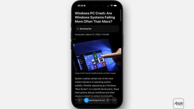 A smartphone displays an article titled "Windows PC Crash: Are Windows Systems Failing More Often Than Macs?" in Safari reading mode, featuring a hand pointing at a Windows screen and the Apple logo in the bottom right corner.