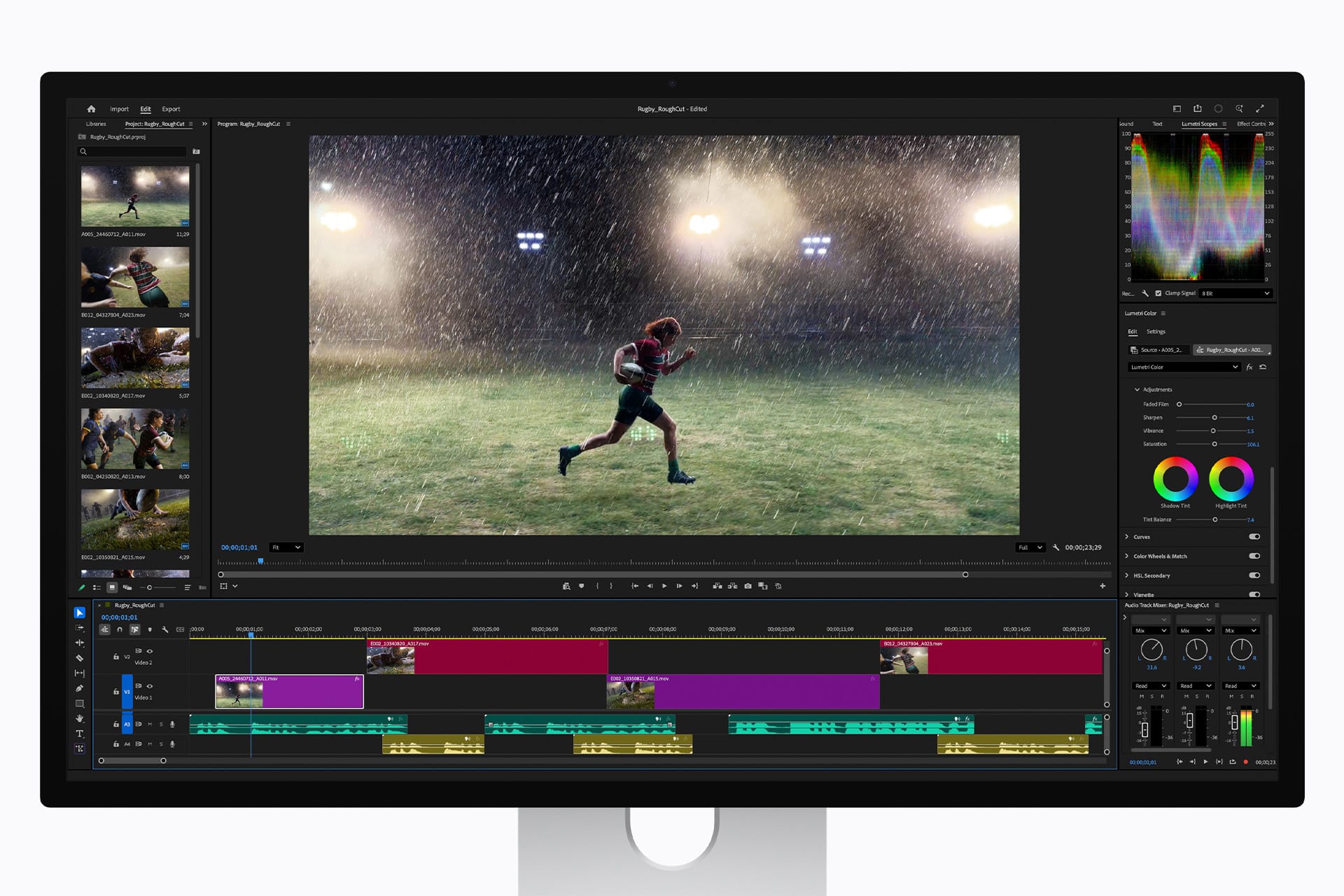A computer screen displays a video editing software interface, showing a scene of a rugby player running on a rainy, illuminated field, with various editing timelines, color tools, and preview panels visible.
