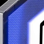 A close-up of an electronic device featuring a perforated metallic edge and a blue-lit, dotted LED panel next to a white and black rectangular display.