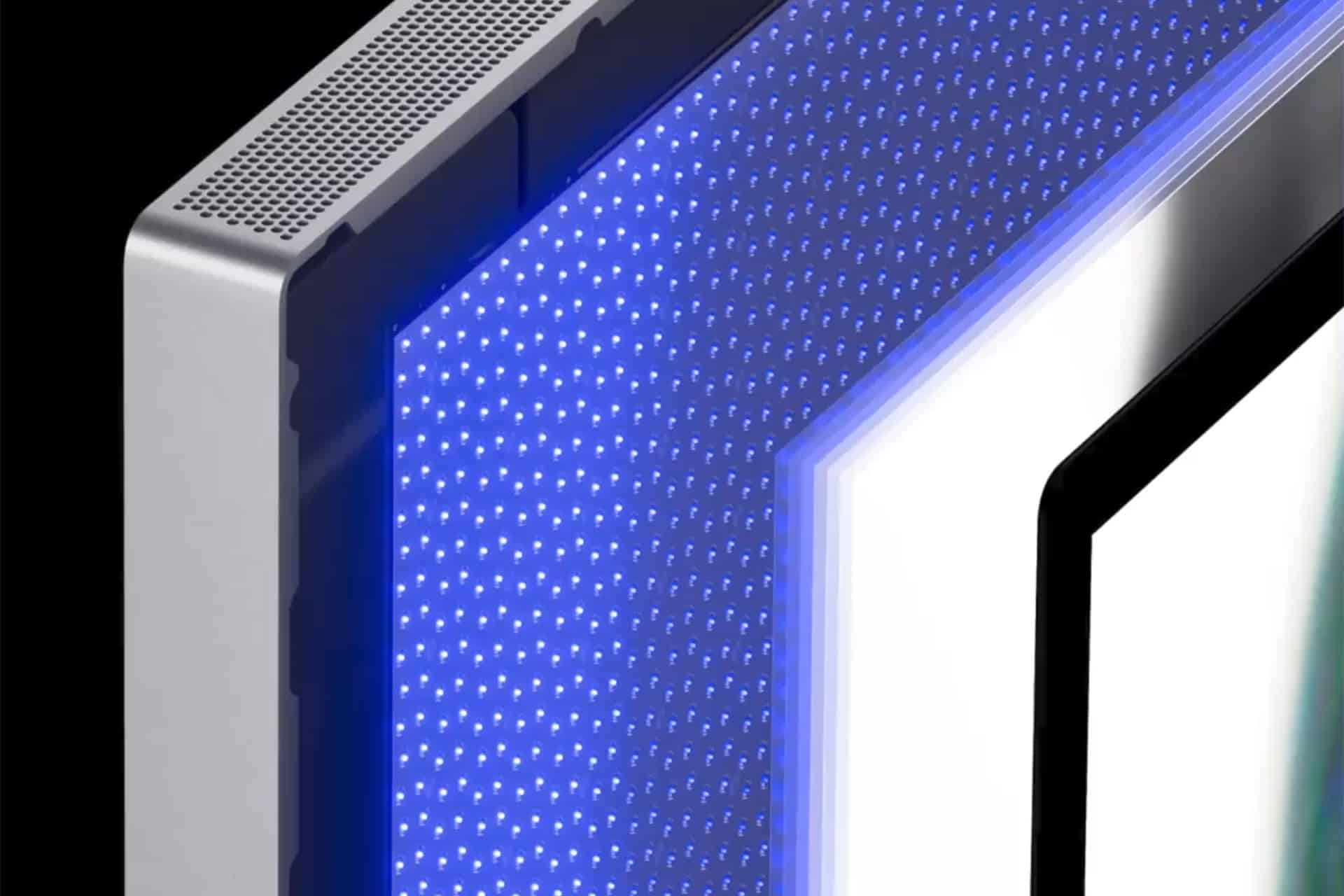 A close-up of an electronic device featuring a perforated metallic edge and a blue-lit, dotted LED panel next to a white and black rectangular display.