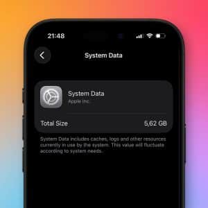 A smartphone screen displays the "System Data" section, showing 5.62 GB used. Text explains system data includes caches, logs, and iOS System Files. The background features a colorful gradient.