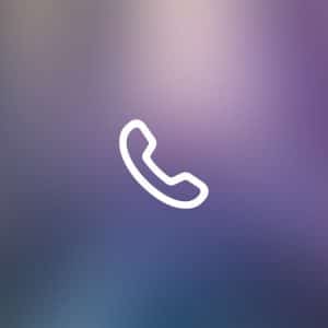 White telephone handset icon centered on a blurred, gradient background with blue, purple, and pink tones. "Apple" and "iPhone Live Voicemail" appear faintly in the bottom right corner.