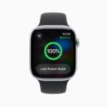 A smartwatch with a black band displays a full Apple Watch Battery at 100%, the time as 10:09, and an option for Low Power Mode on its screen, with the Apple logo in the bottom right corner.