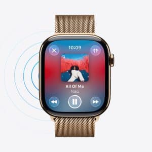 A gold smartwatch with a mesh band displays an Apple Watch Music Sync feature, showing the song "All Of Me" by Nao, album art, play controls, and sound wave graphics on a white background.