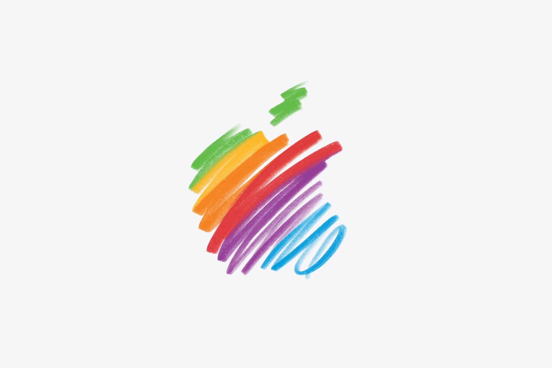 A simple apple shape is drawn with colorful, horizontal crayon lines in green, yellow, orange, red, purple, and blue on a plain white background—@HelloApple brings a playful twist to classic fruit art.