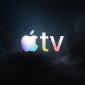 The Apple TV logo with a glowing, iridescent effect is centered on a dark, cloudy background. "Apple TV The Studio" appears faintly in a small rounded square at the bottom right corner.