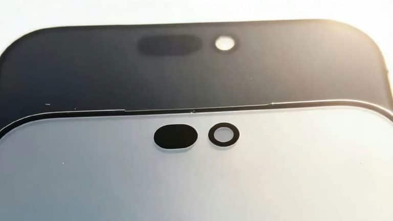 Close-up of two smartphone screens, one black and one white, each showing front camera cutouts and sensor holes, possibly hinting at a Dynamic Island design. Bright light is visible in the background in these first images from an iPhone 18 leak.