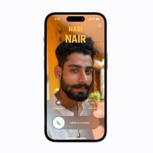 A smartphone screen displays an incoming call from "Hari Nair," featuring a photo of a man with dark hair and beard. Options to message, remind, answer, or initiate iPhone Contact Merge appear at the bottom.