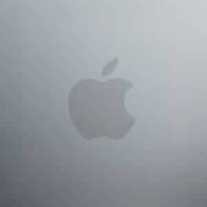 The image shows a silver metallic surface with the Apple logo in the center, which is a stylized silhouette of an apple—iconic to every MacBook Neo—with a bite taken out on the right side and a small leaf on top.