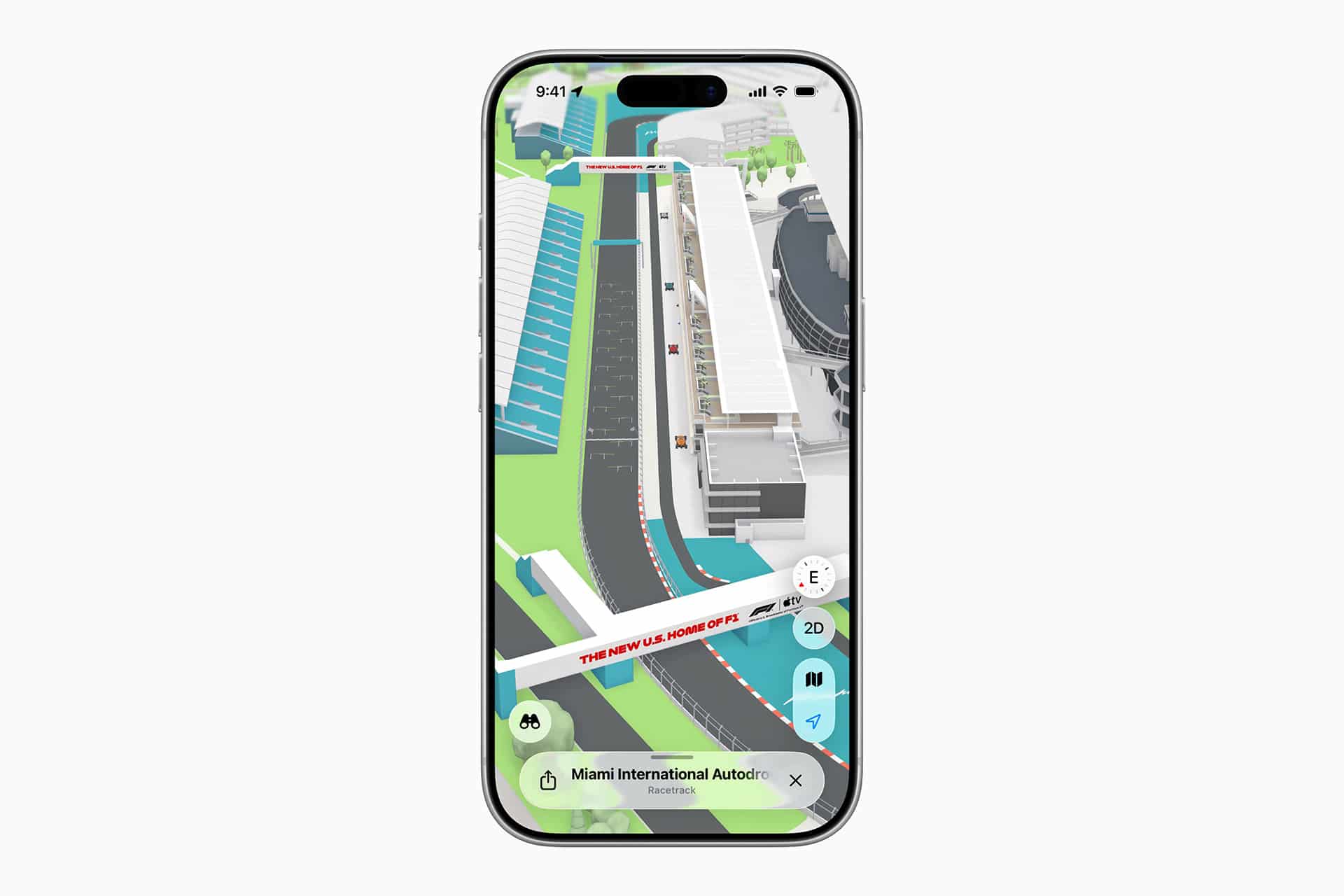 A smartphone displays a 3D map of the Miami International Autodrome, highlighting the Miami Grand Prix racetrack, grandstands, and surrounding buildings in vivid detail.