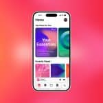 A smartphone displaying an Apple Music app interface with "Your Essentials" playlist, recently played tracks, and a pink-orange gradient background. The Apple logo is in the corner, highlighting seamless Apple Music Favorite sync across devices.