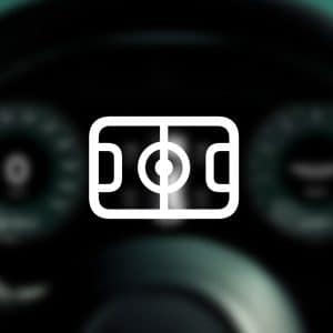 A white outline of a soccer field icon is centered over a blurred car dashboard with visible speedometer and gauge dials, highlighting Apple Sports widgets. The Apple logo appears in the bottom right corner.