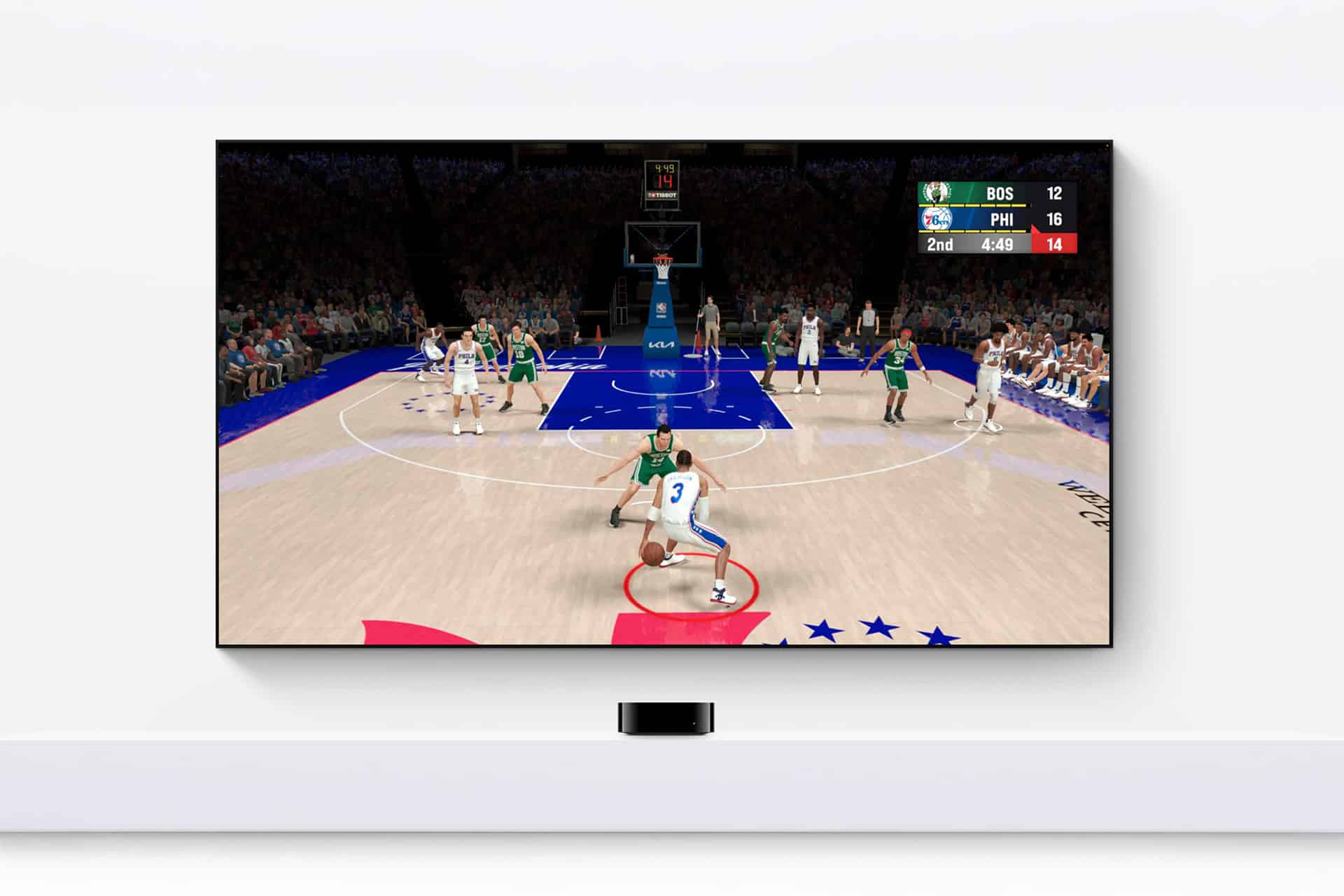 A TV mounted on a white wall shows a basketball video game as part of an Apple TV gaming setup, with a player in white dribbling toward the basket against green and the scoreboard reading BOS 12, PHI 16, 2nd quarter, 4:48 left.