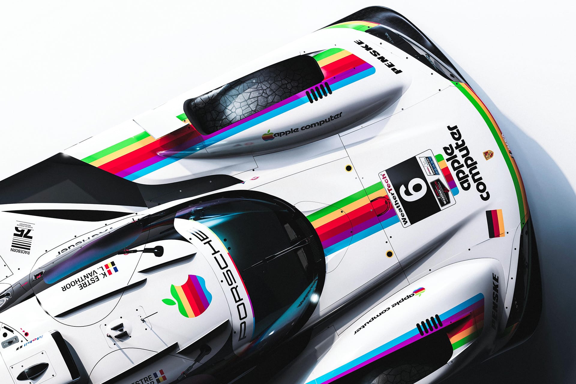 Top view of a Porsche Apple race car, number 6, showcasing retro rainbow-striped Apple Computer logos and sleek aerodynamic design details on the white body.
