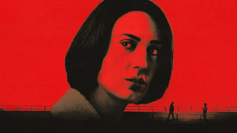 A woman’s face, tinted red and black, dominates the image against a bold red background. Part of the Unconditional series, two small silhouetted figures walk along a fence below, creating a dramatic contrast.