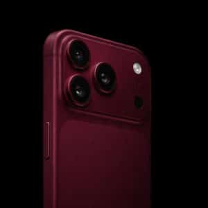 Close-up of a dark red iPhone 18 Pro, highlighting its triple camera setup and flash against a black background. The Apple logo appears in the lower right corner, showcasing one of the striking new iPhone 18 Pro colors.
