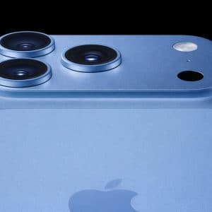 Close-up of the back of a blue smartphone, highlighting its sleek design, triple camera module, flash, Apple logo, and one of the new iPhone 18 Pro colors.