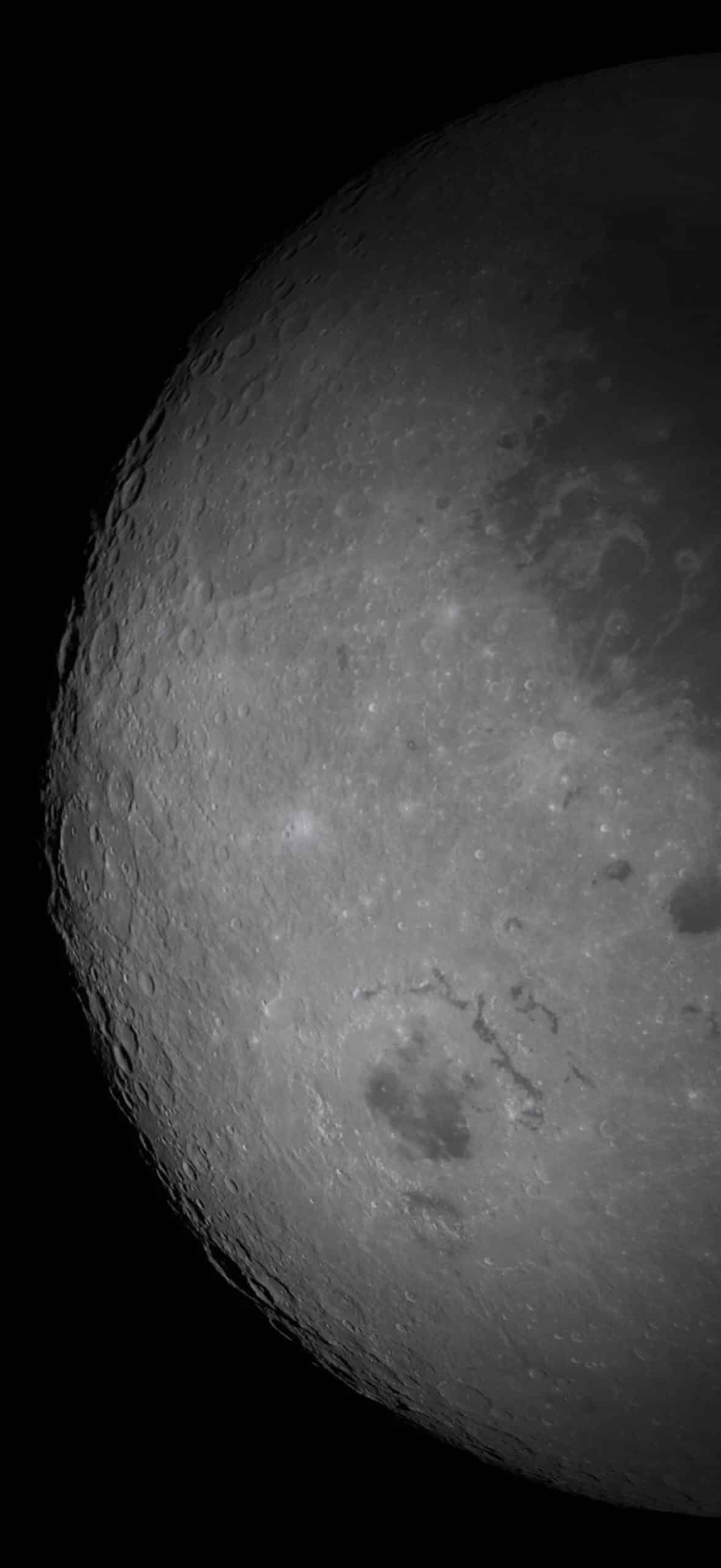 A close-up view of the moon's surface, captured with striking detail reminiscent of Apple GPU memory precision, shows detailed craters and rough textures, with the left edge partly shadowed against a black background.